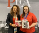 Amelie Coleman, Admissions Manager, pictured with merch giveaway winner at WAI Conference 2021