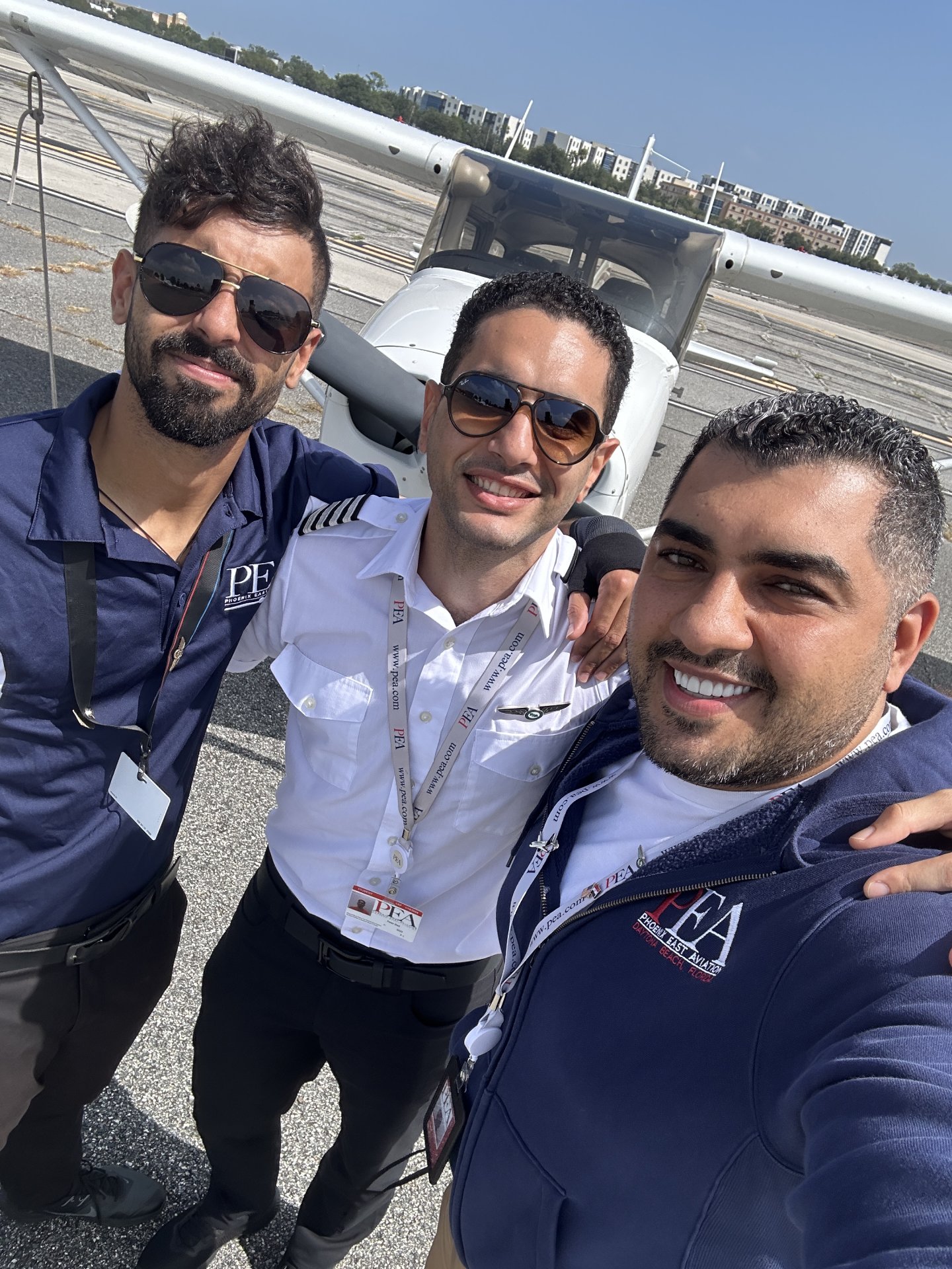 Peter(Middle) with Moe, Admissions Officer(R) selfie in front of Cessna 172 with fellow student on the right.