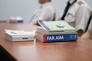 close up shot of FAR AIM and Private Pilot 2018 textbooks