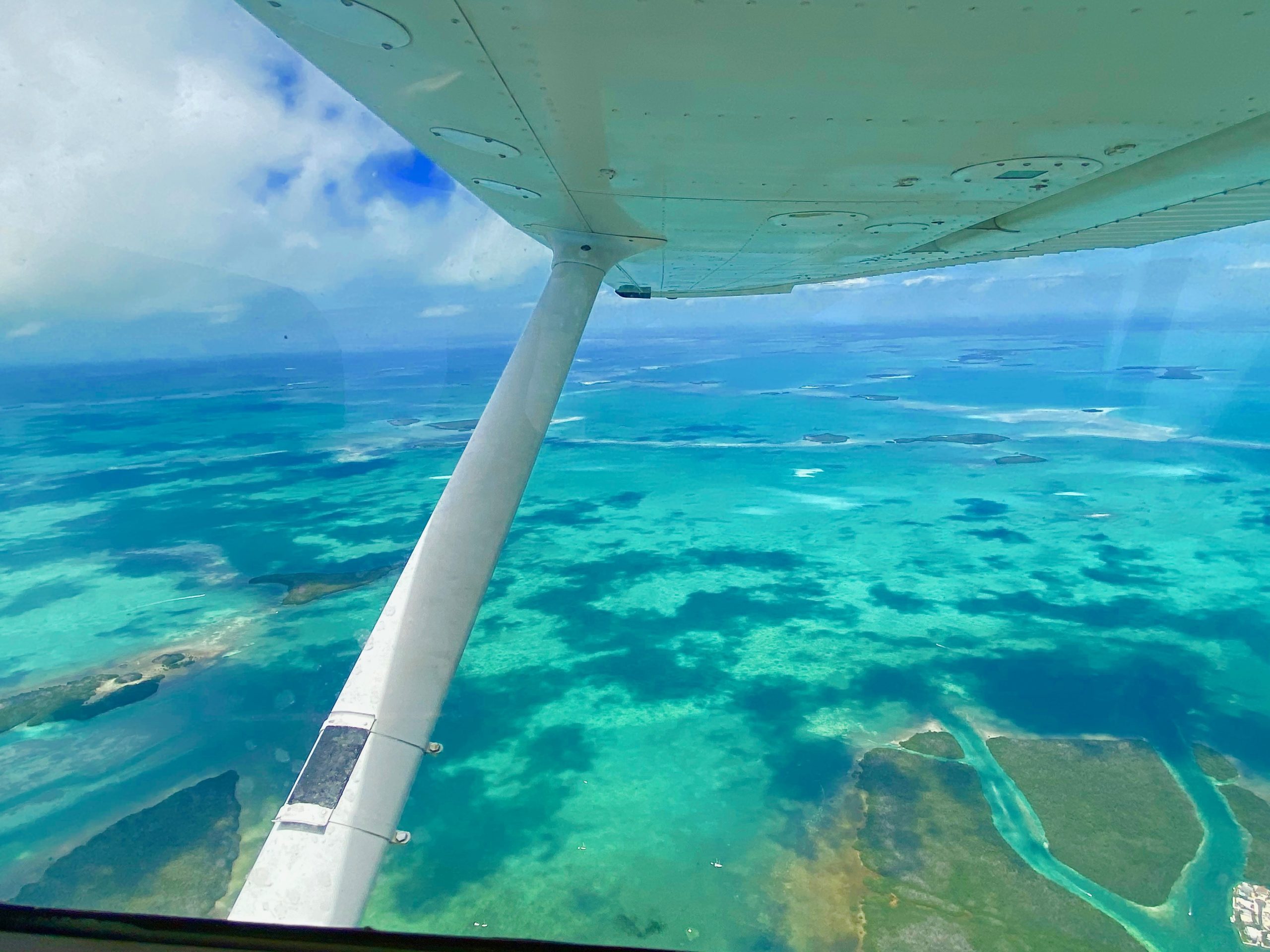 Overlooking the Florida Keys from Cessna window and can see the wing in photo