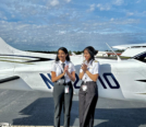 Xochitl and friend female pilot clapping in front of Cessna 172 on KFIN ramp