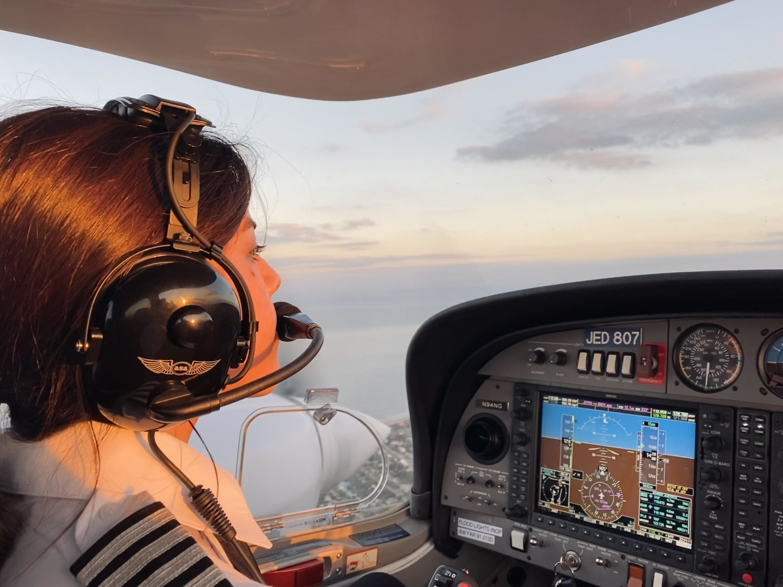 Xochitl side profile shot of flying Diamond DA42 in sunset