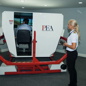 Exterior shot of FMX Full Motion Simulator being used by student