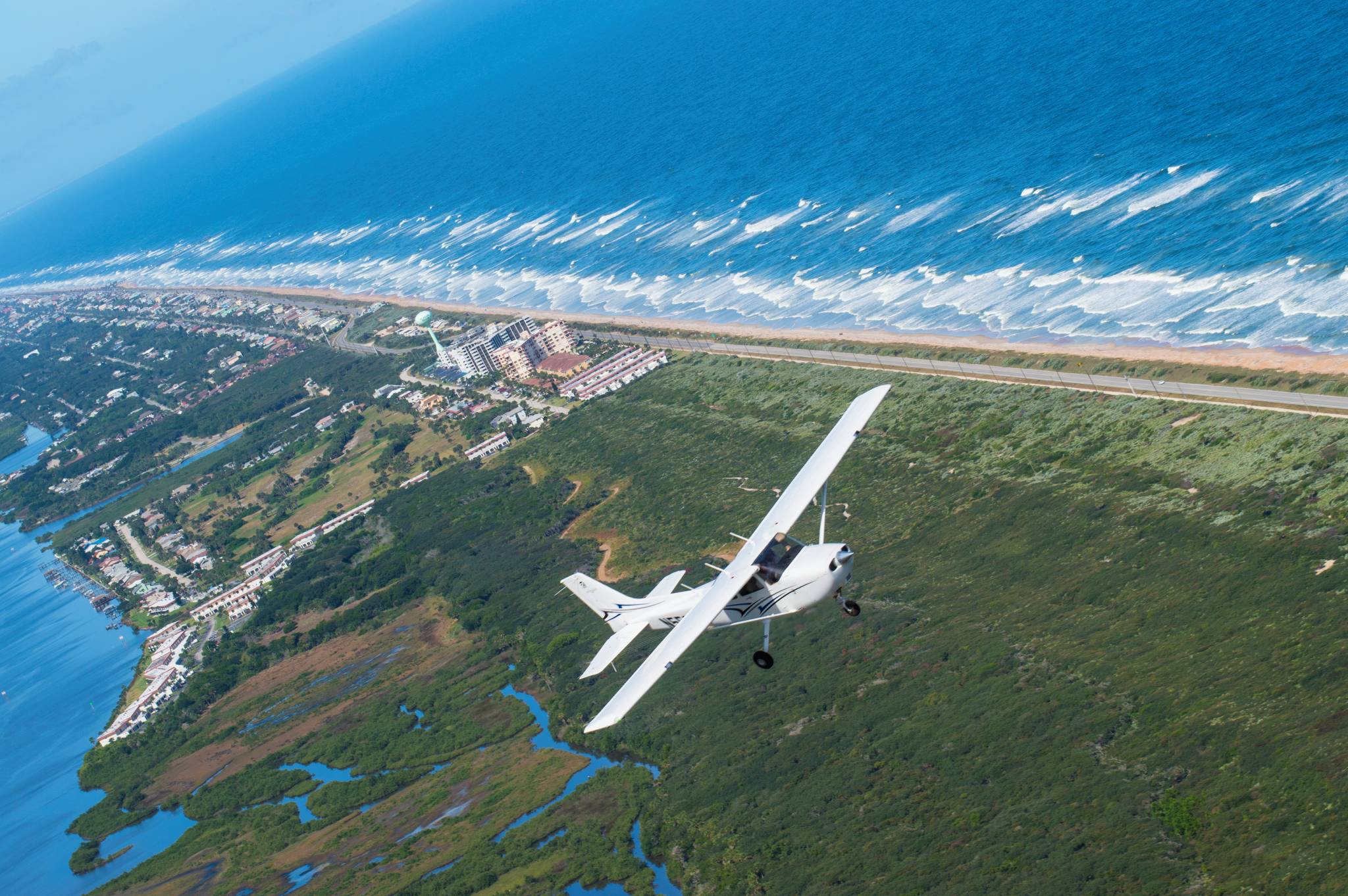 aerial view of Daytona Beach coast with PEA Cessna 172 flying