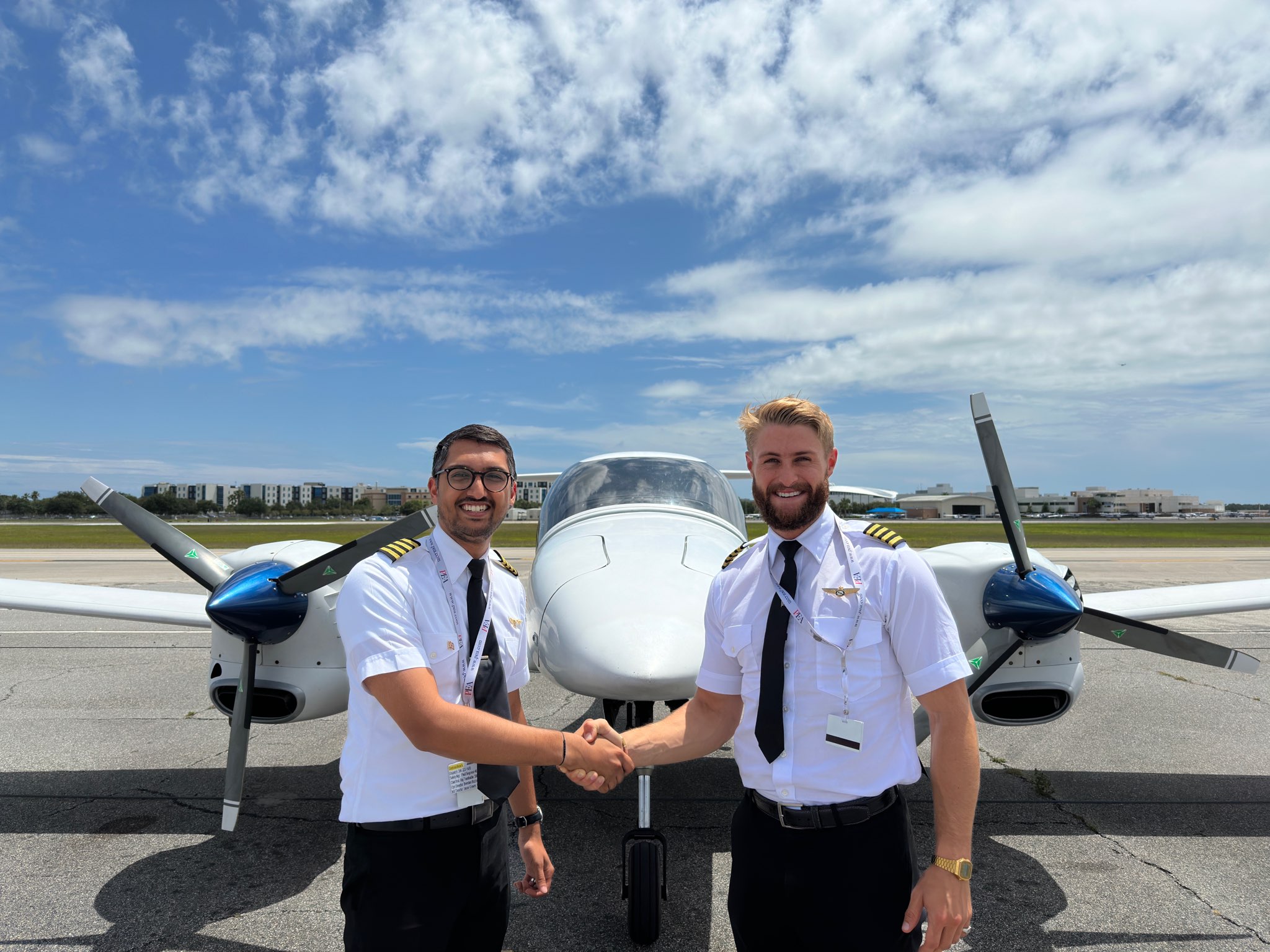 Brenton Scott Martin (on the right) shaking hands with his student Gaurang Gang (on the left), in front of Diamond DA42