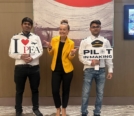 Amelie Coleman (M) with two senimar attendees holding marketing signs