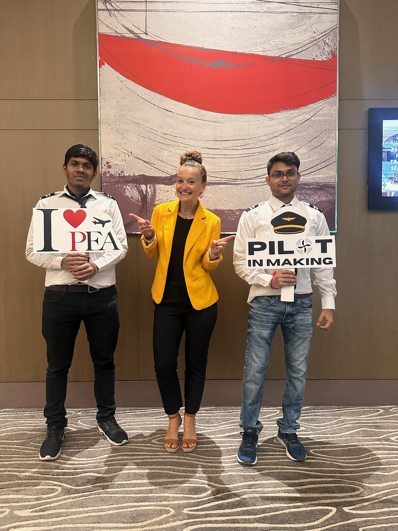 Amelie Coleman (M) with two senimar attendees holding marketing signs