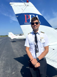 Tegvir Anand medium shot in front of PEA Cessna 172 tail