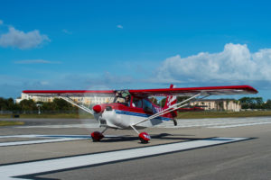 Wide action shot of PEA's Super Decathlon aircraft on runway