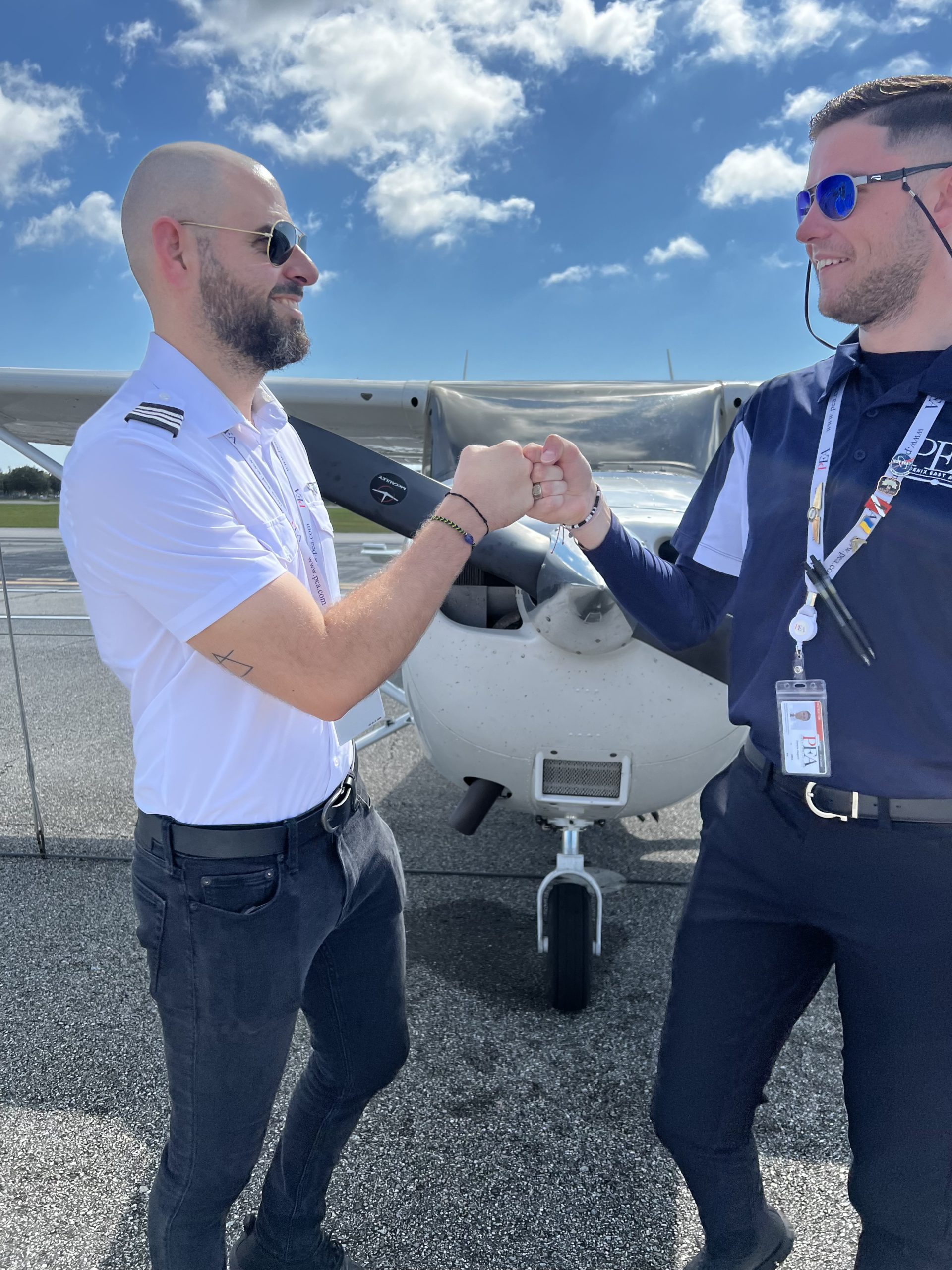Dan Zagorii (R) with Student Shariff Attoui (L) fist pounds in front of Cessna 172