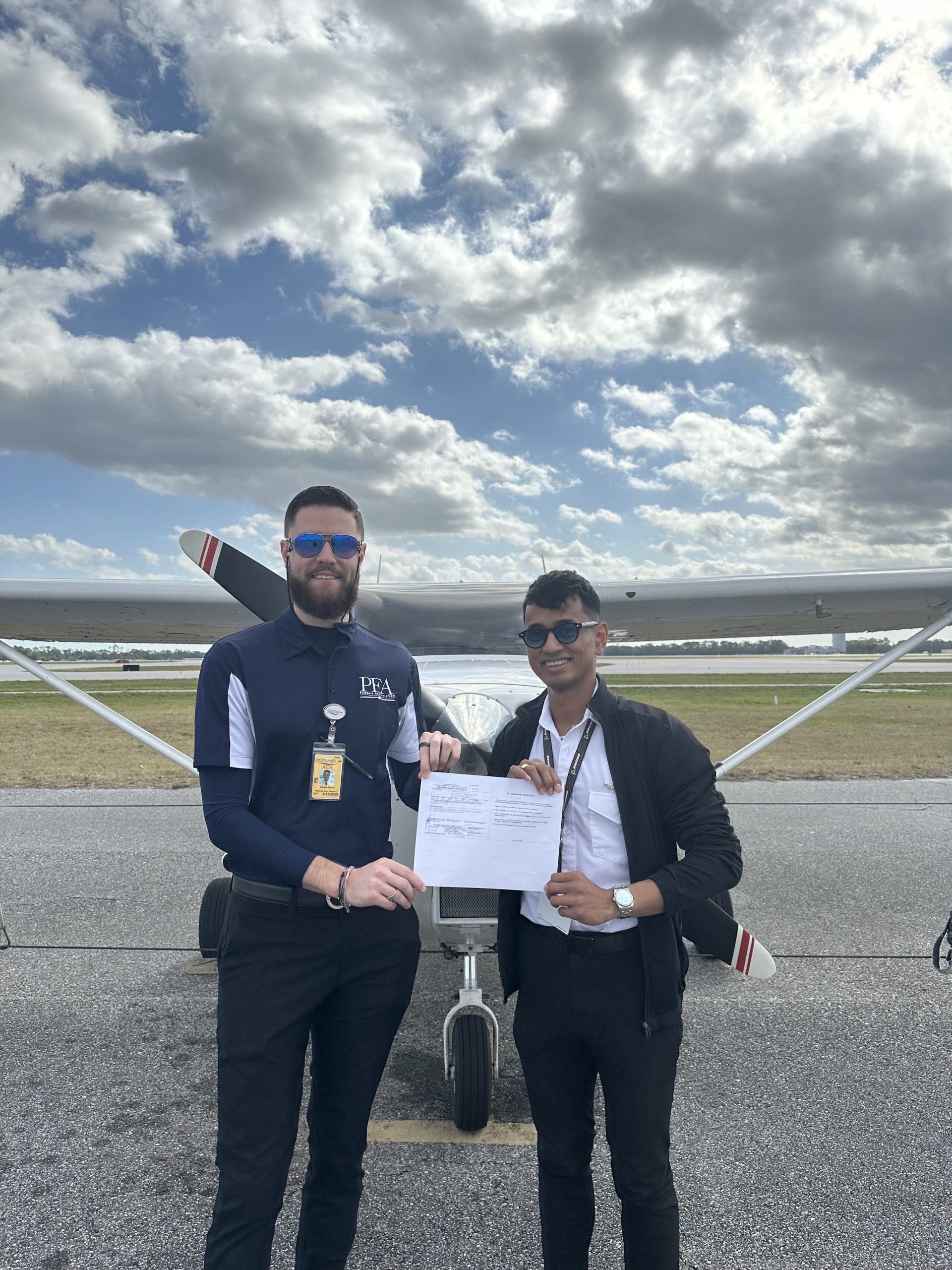 Dan Zagorii with student Tony Argonza celebrating his accomplishment in front of Cessna 172