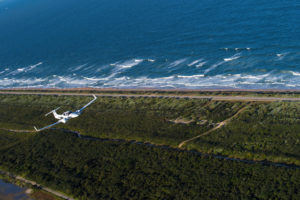 PEA Diamond DA42 flying over the coast of Daytona Beach, Florida