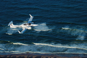 PEA Diamond DA42 Twin Star flying over the coast of Daytona Beach, Florida