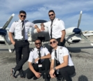 group shot of Omar (front, right) with friends in front of Diamond DA42