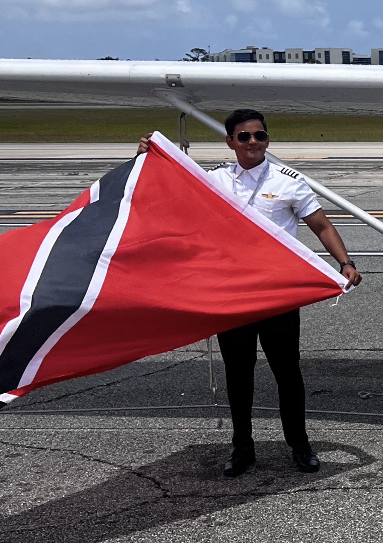 Dhaarinesh Balkison holding Trinidad and Tobago flag