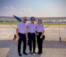 Dhaarinesh Balkison (in the middle) completion photo standing in front of Cessna 172