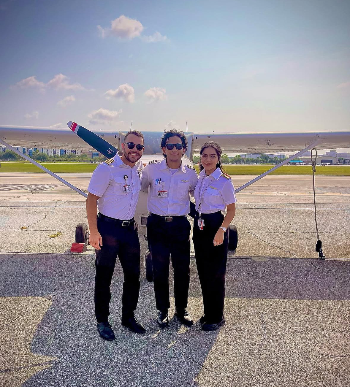 Dhaarinesh Balkison (in the middle) completion photo standing in front of Cessna 172