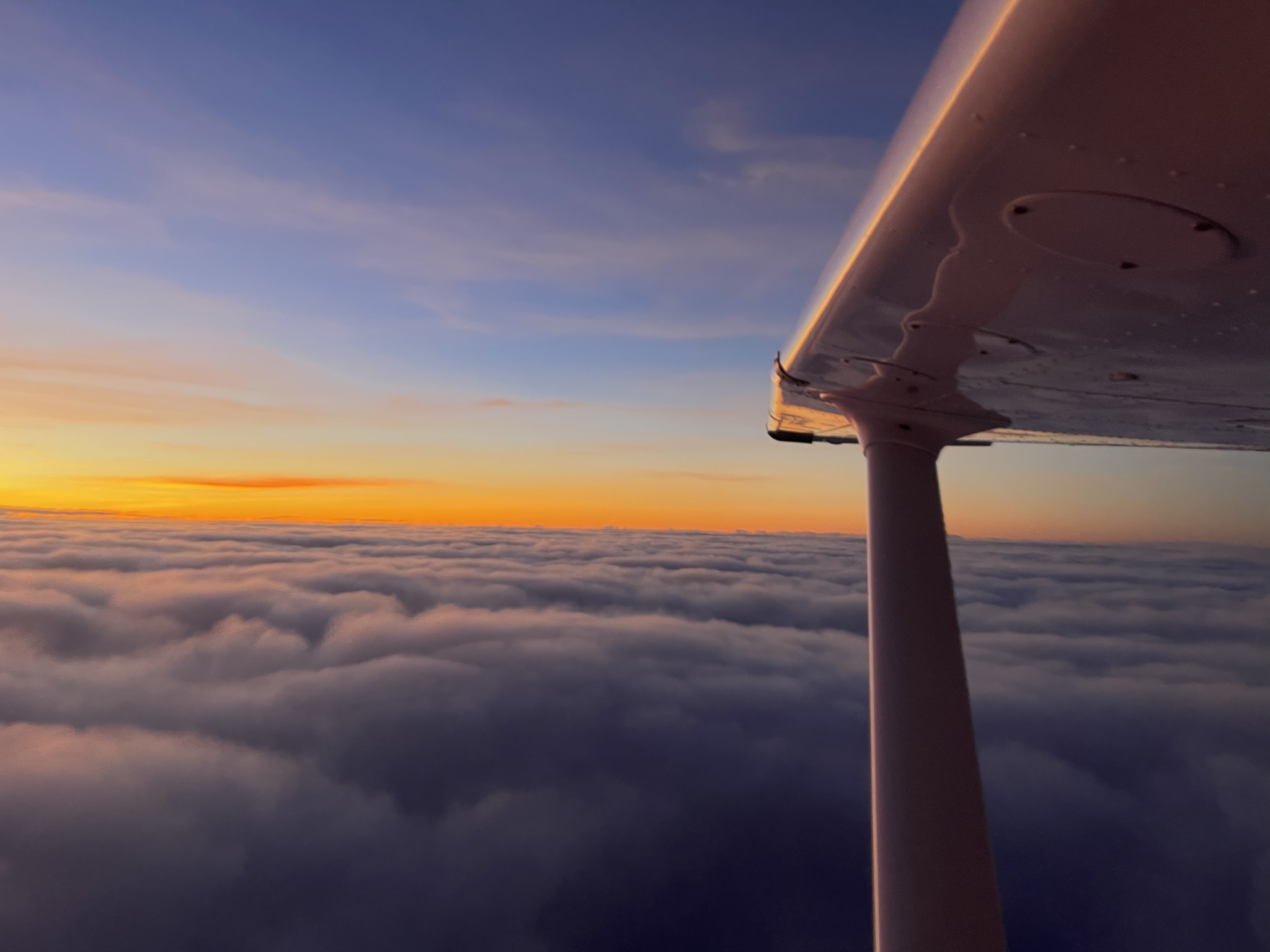 Scenic shot of clouds with Cessna wing in shot