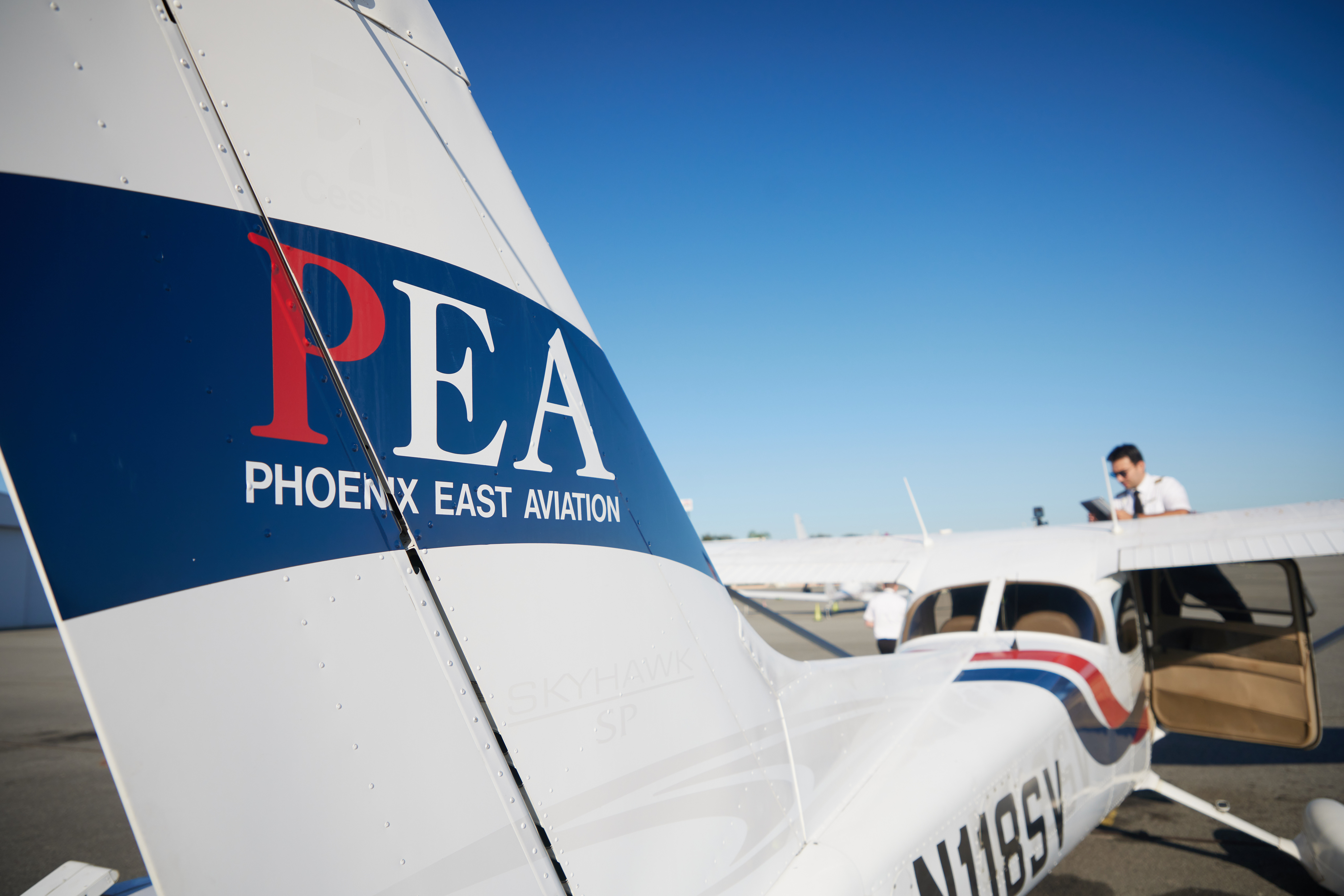 a small plane with a P.E.A. logo