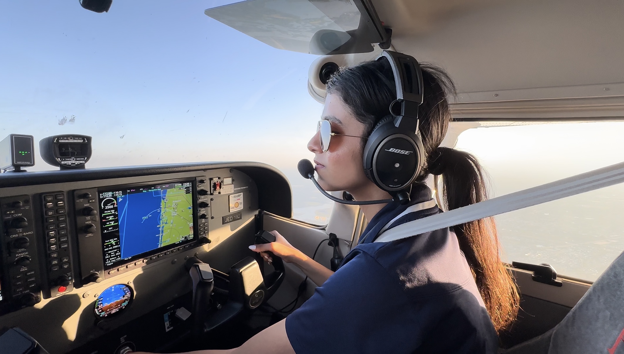 Yukta in flight with bose headset on