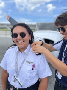 Lainie Zinser (L) receiving CPL epaulettes from instructor (R)