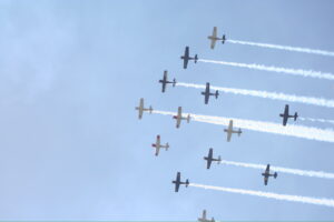 planes in the sky during daily airshow at EAA Oshkosh AirVenture