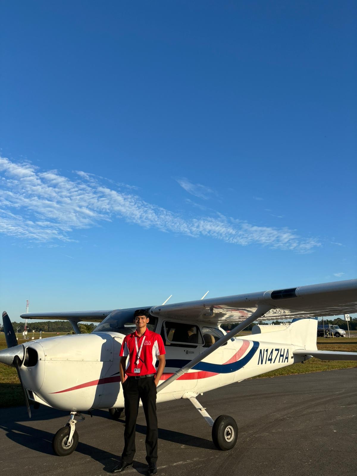 Ethan Lopes standing next to Cessna 172 with hands in his pocket