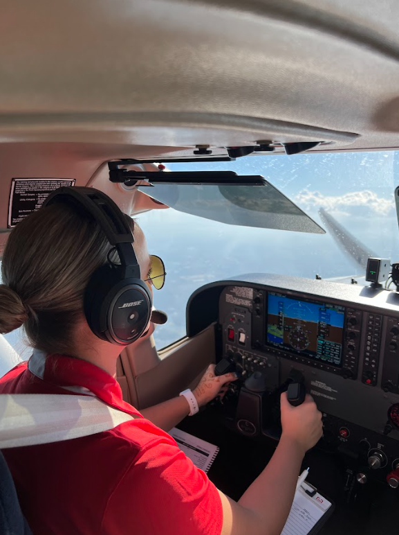 Student pilot flying a single-engine training aircraft while monitoring flight instruments and maintaining control inputs.